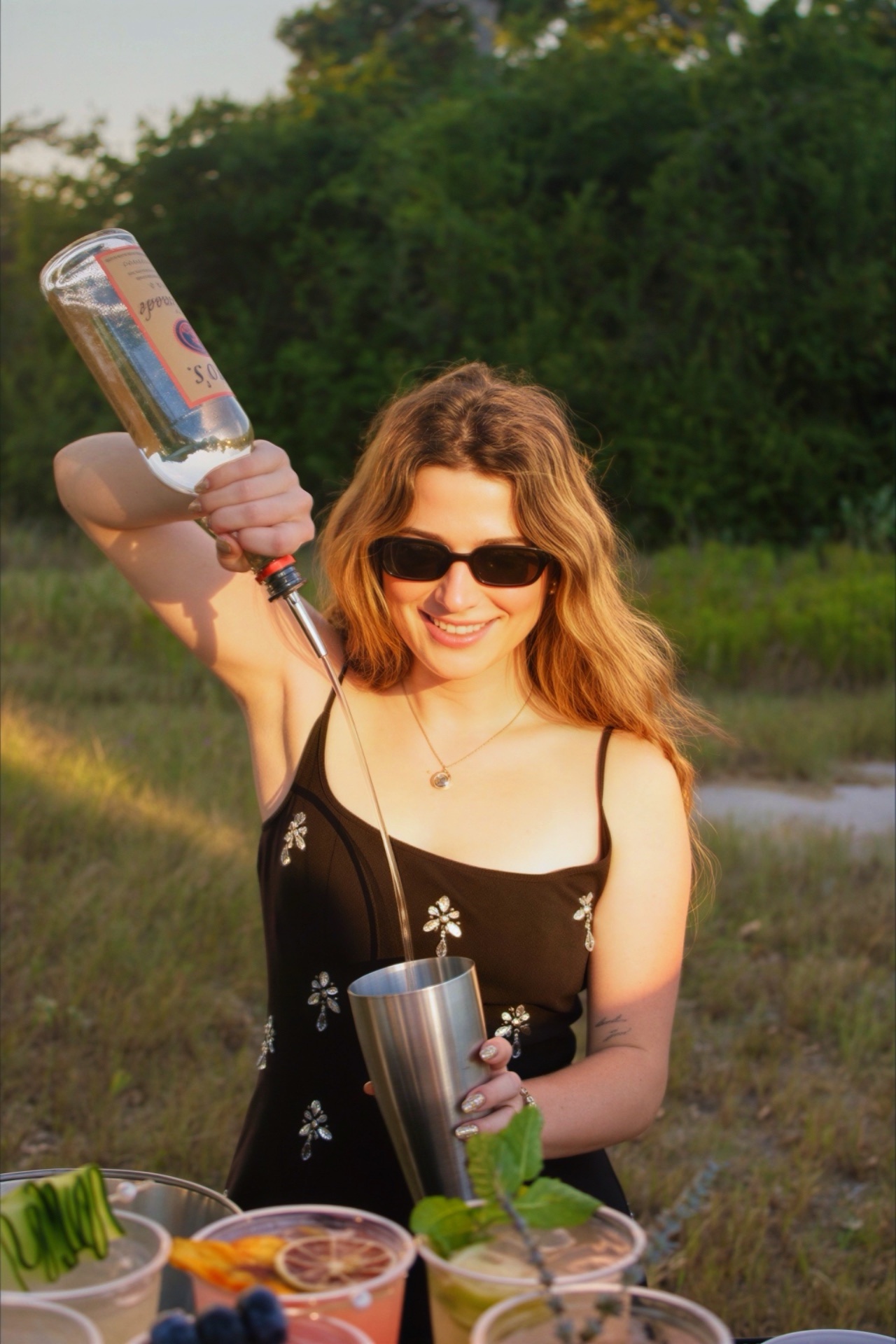 Morgan, owner of Book That Bar, pouring a drink behind the bar
