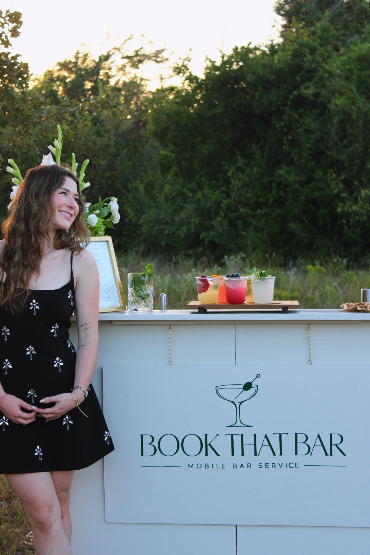 Morgan standing beside the Book That Bar mobile bar