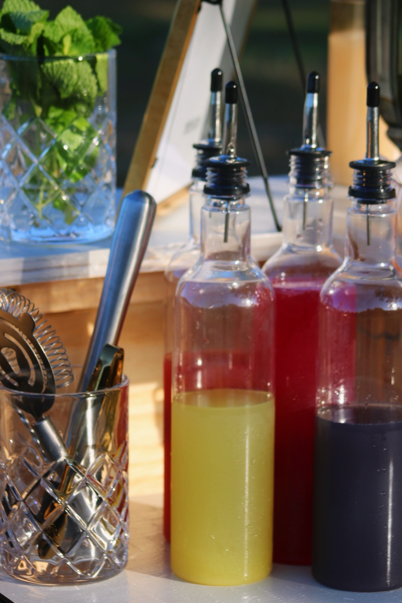 Colorful cocktail syrups and bar tools ready for service