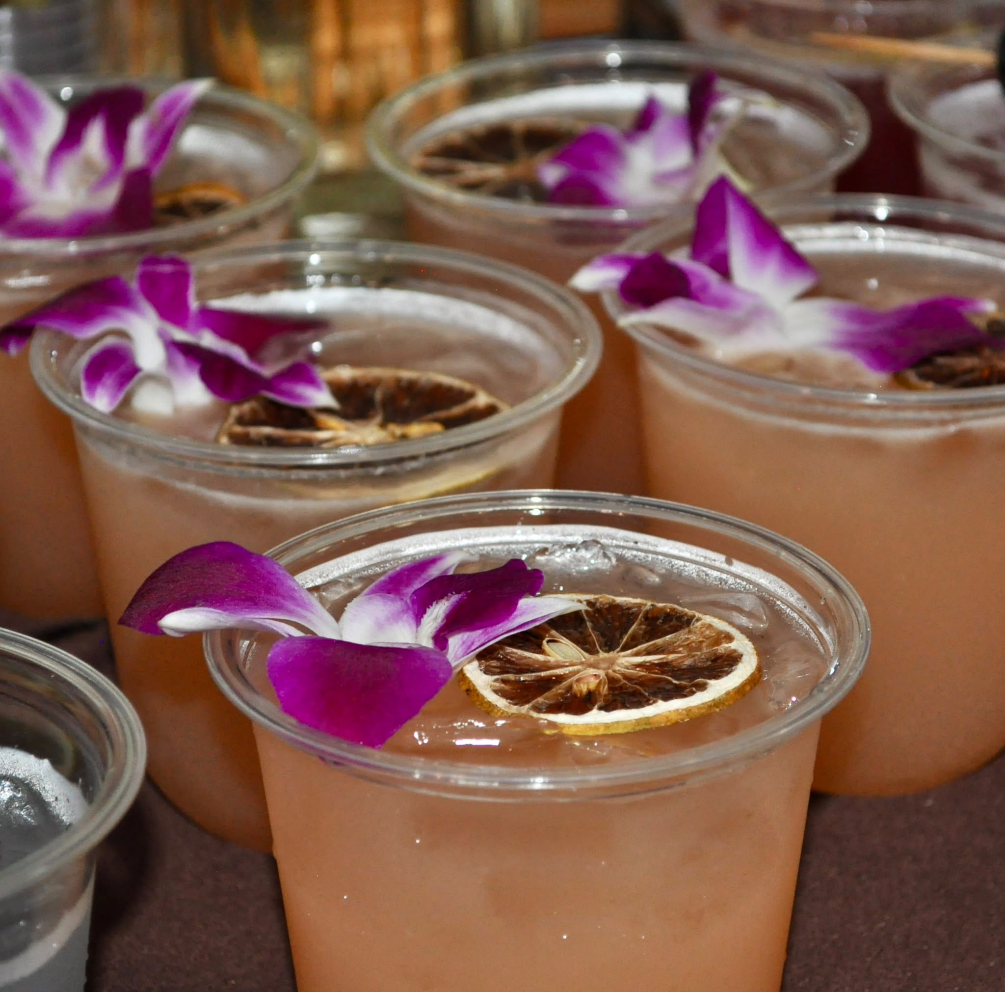 Paloma cocktails with purple orchids and dried citrus