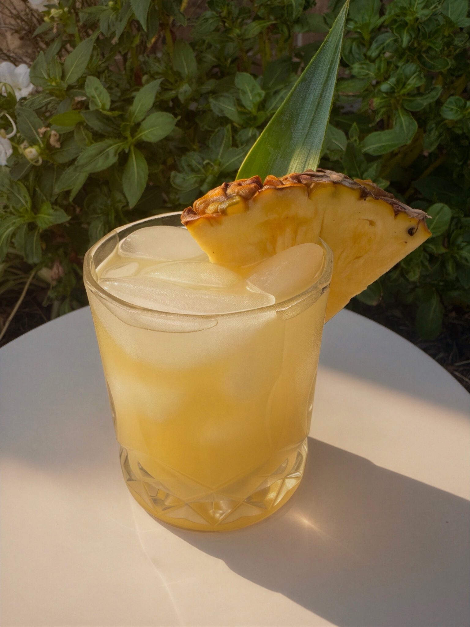 Pineapple Margarita over ice with a fresh pineapple wedge garnish
